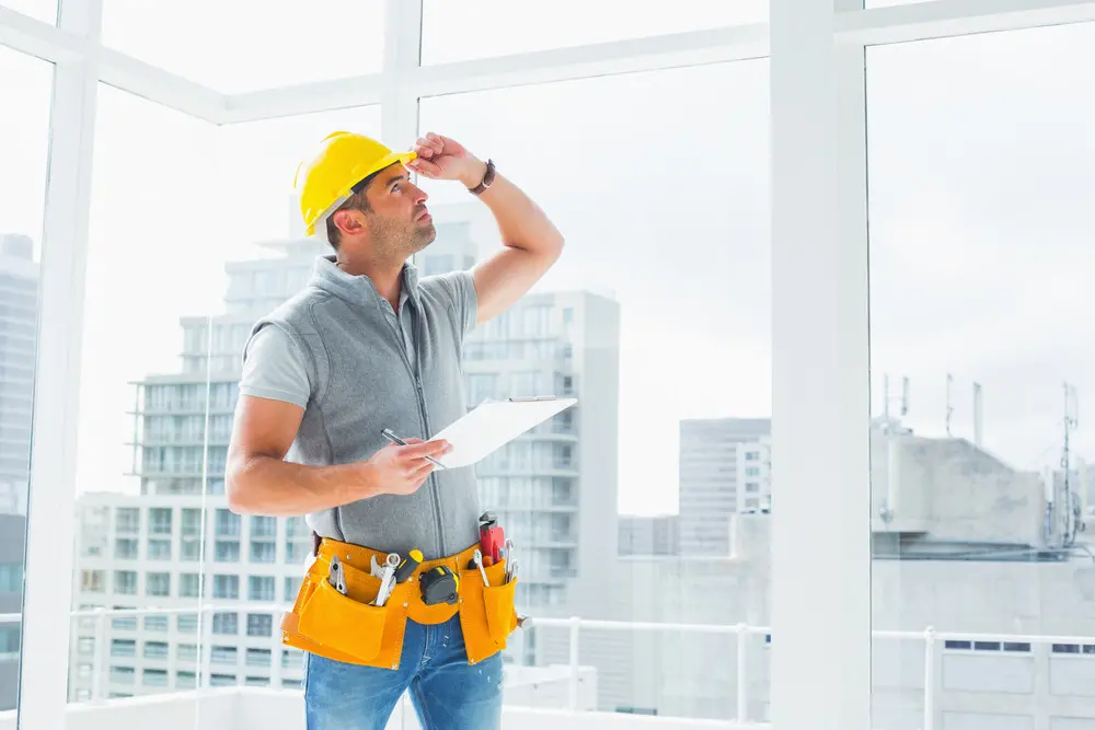 Construction worker inspecting a ceiling